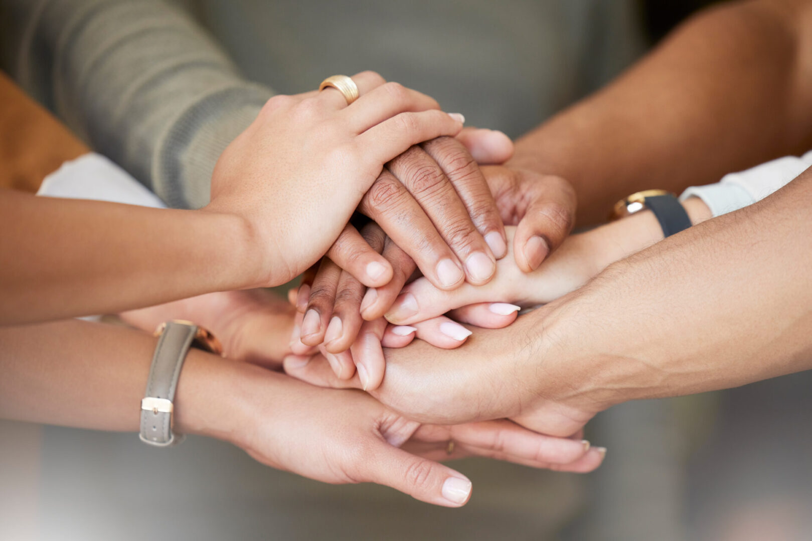 A group of people holding hands in the middle.