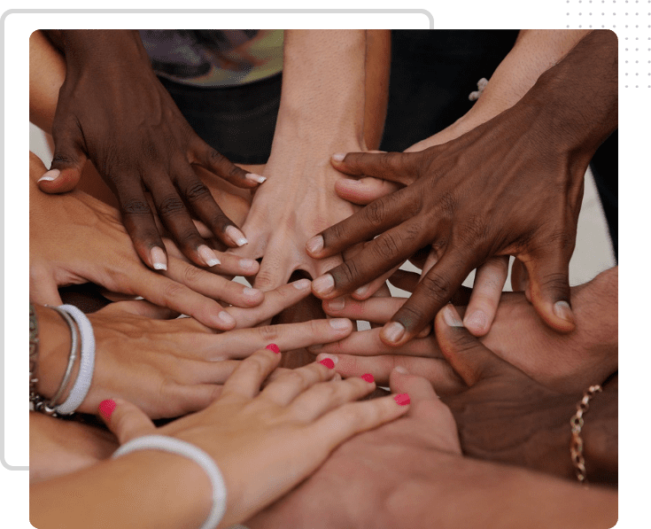 A group of people with their hands together.