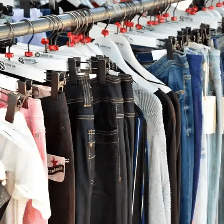 A rack of clothes hanging on the side of a wall.