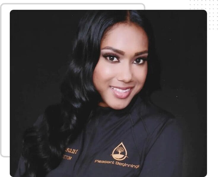 Smiling woman in black jacket with logo